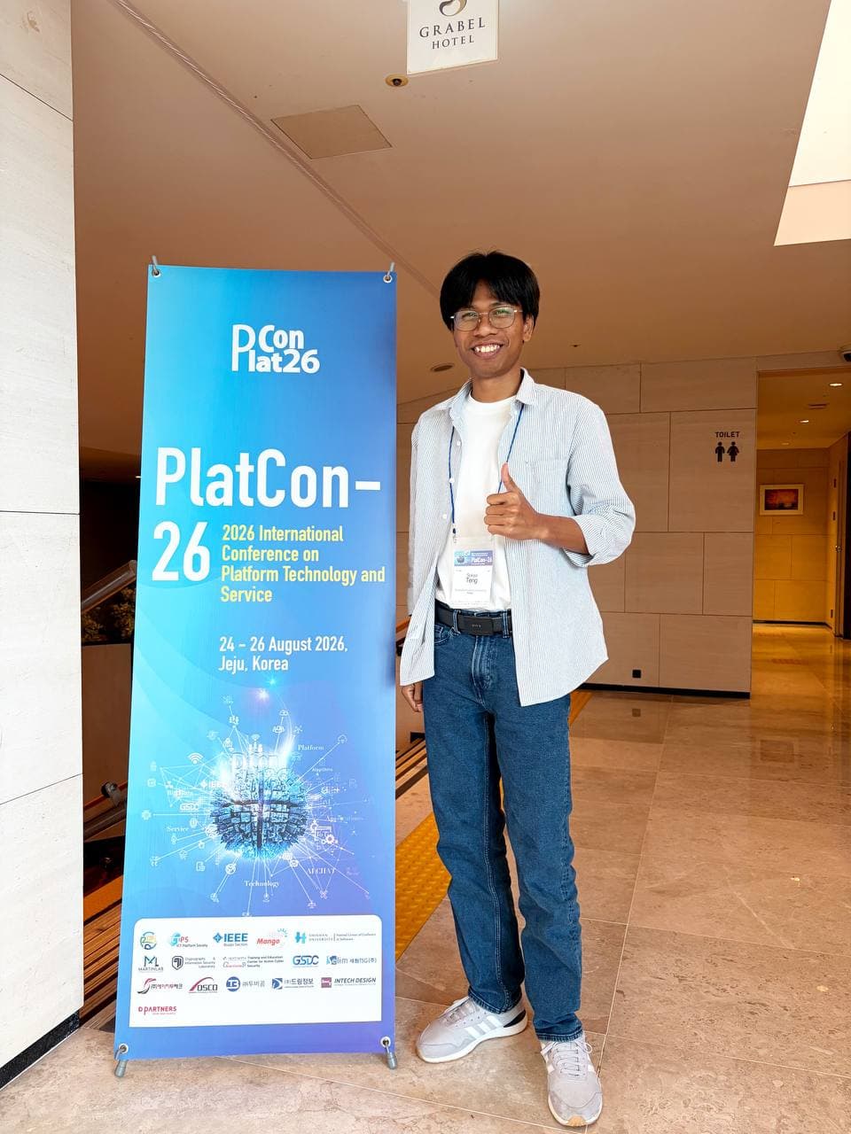 TENG Sokea standing beside the PlatCon 2026 conference banner